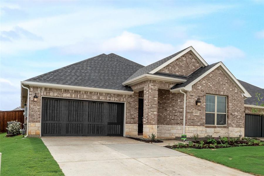 Front exterior of a new home in Spiritas Ranch, Little Elm, TX, highlighting curb appeal (Image 25). Front exterior of a new home in Spiritas Ranch, Little Elm, TX, highlighting curb appeal (Image 25).