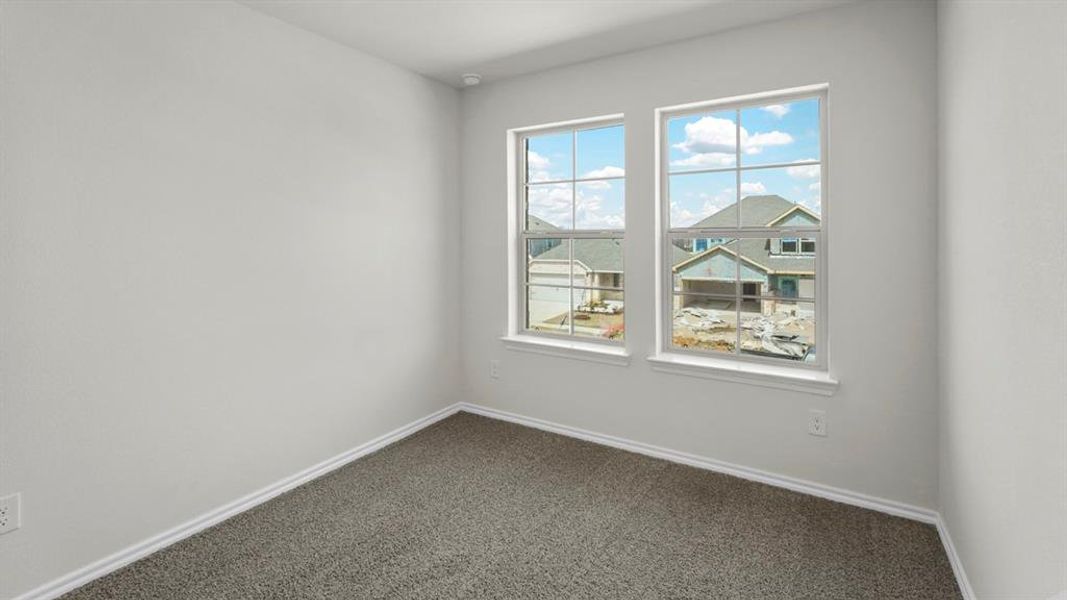 This room features two windows and light gray carpeting