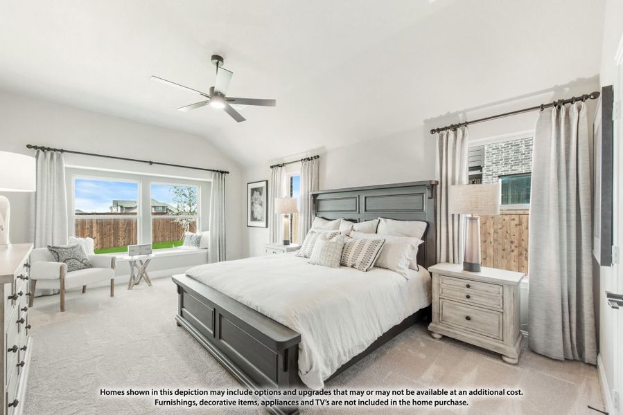 Bedroom with dark wood bed frame, vaulted ceiling, ceiling fan, and large windows with backyard view Bedroom with dark wood bed frame, vaulted ceiling, ceiling fan, and large windows with backyard view