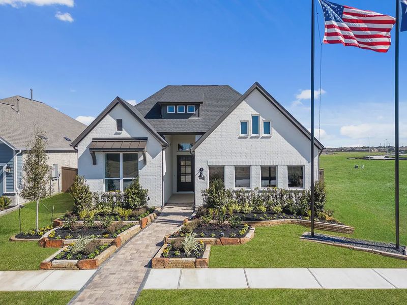 Front exterior of a new home in Blue Heron, Mont Belvieu, TX, highlighting curb appeal (Image 27).