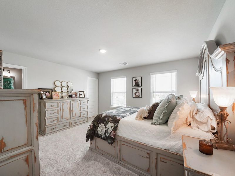 This secondary bedroom features its own private ensuite, offering comfort and convenience for guests or multigenerational living.