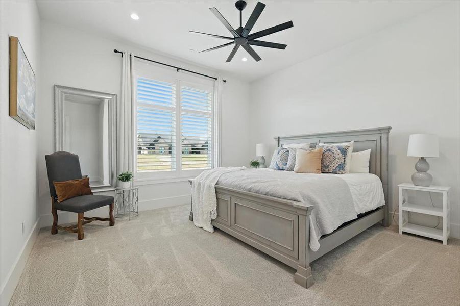 Bedroom featuring light colored carpet, recessed lighting, and a ceiling fan Bedroom featuring light colored carpet, recessed lighting, and a ceiling fan