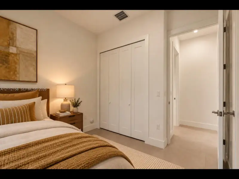 Bright, versatile bedroom with clean finishes, easy-care tile flooring, and a bi-fold closet
