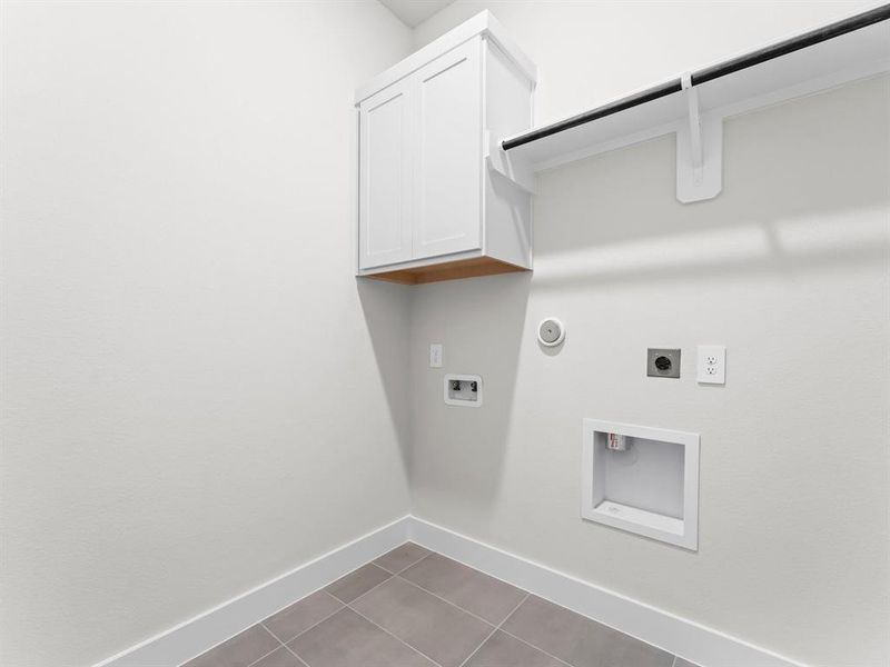 Utility Room with Washer and Dryer Connections, Storage Cabinet, Hanging Bar, and Vent Fan.