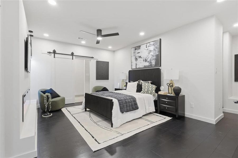 Spacious room featuring dark wood-finish flooring, recessed lighting, and a ceiling fan