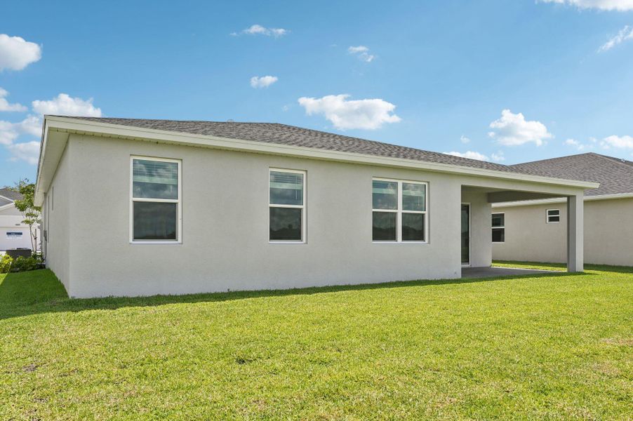 Front exterior of a new home in Hampton Park - Signature Series, Vero Beach, FL, highlighting curb appeal (Image 19).