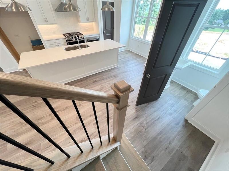 Stairs featuring wood finished floors and baseboards