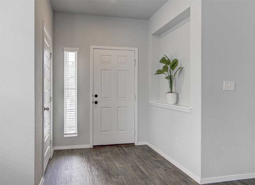A well-lit entry with rich wood flooring welcomes you home. A well-lit entry with rich wood flooring welcomes you home.