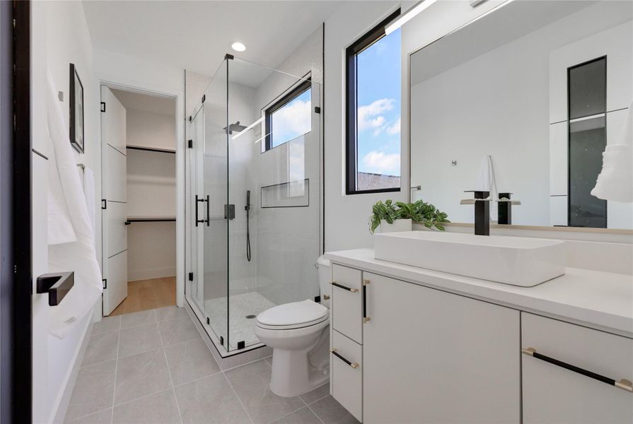 Full bathroom featuring vanity, a stall shower, light tile patterned floors, a spacious closet, and recessed lighting
