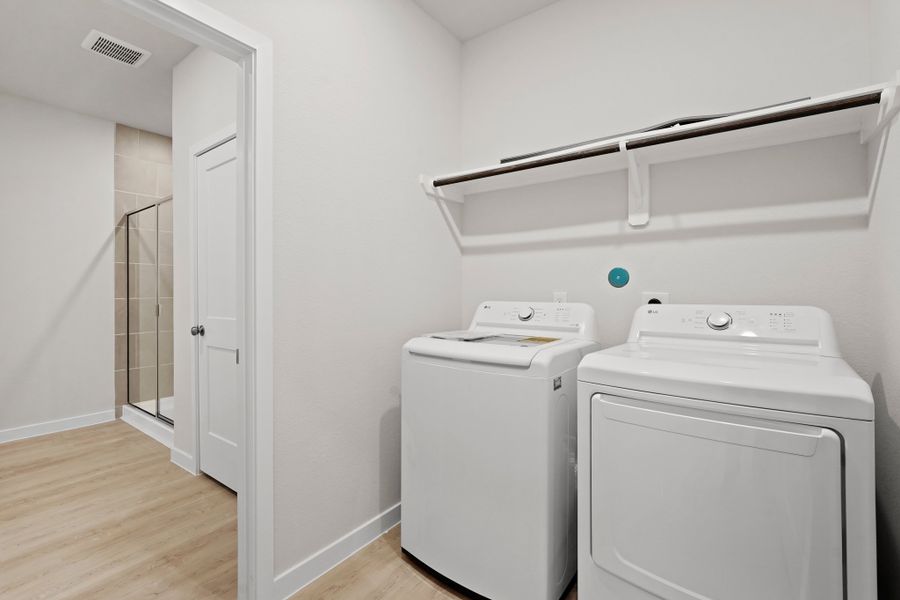 A laundry room with a washer and dryer. A laundry room with a washer and dryer.