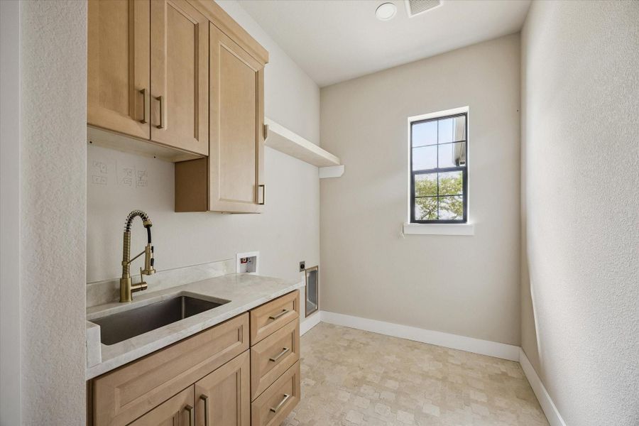 Laundry room with sink and storage closet.