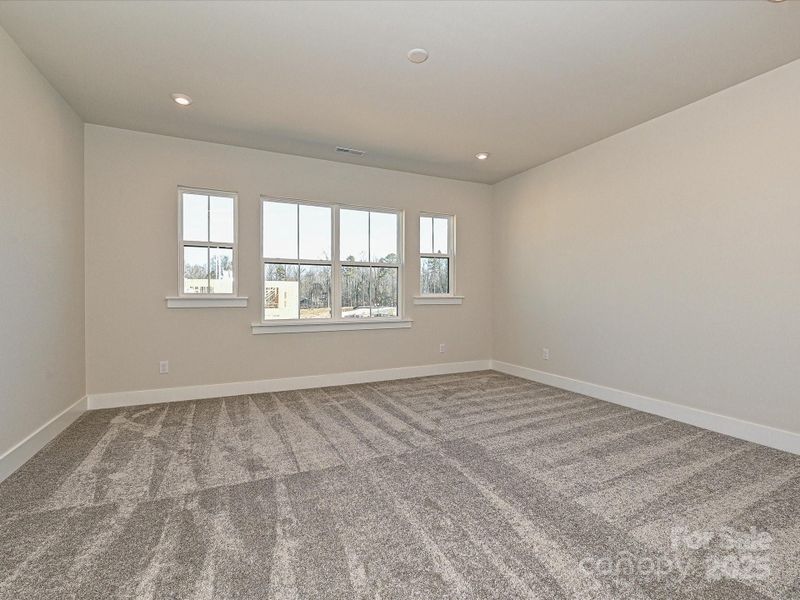 Primary suite with large bright windows.