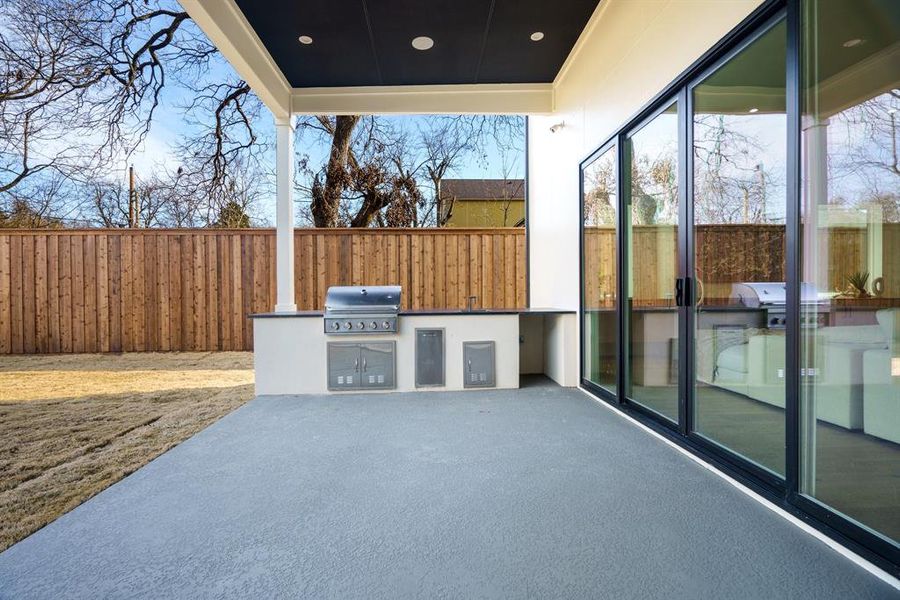 View of patio with an outdoor kitchen and grilling area