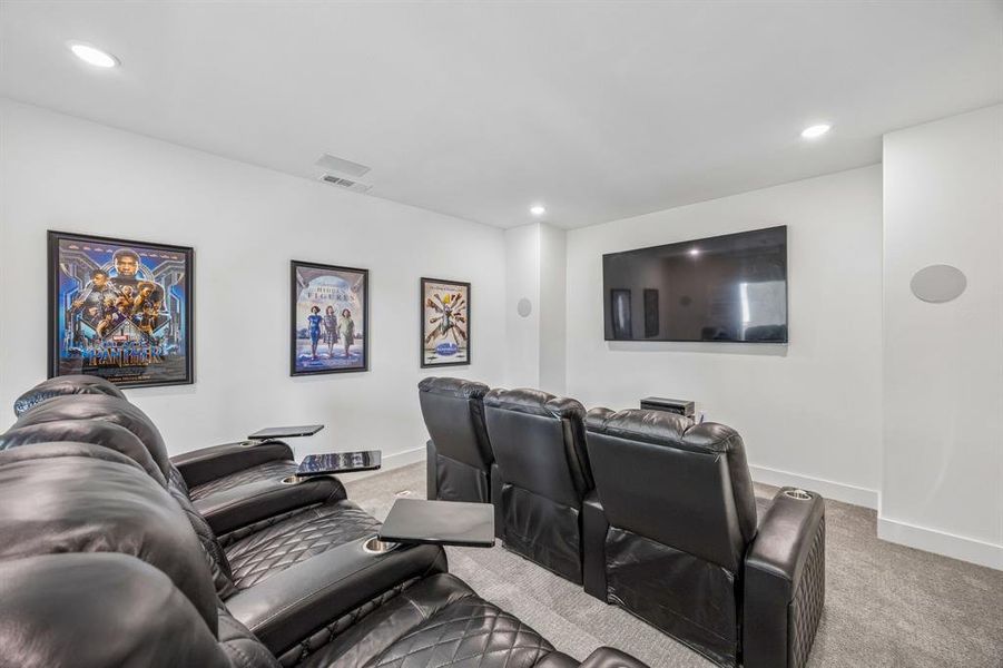 Home theater room featuring light colored carpet and recessed lighting