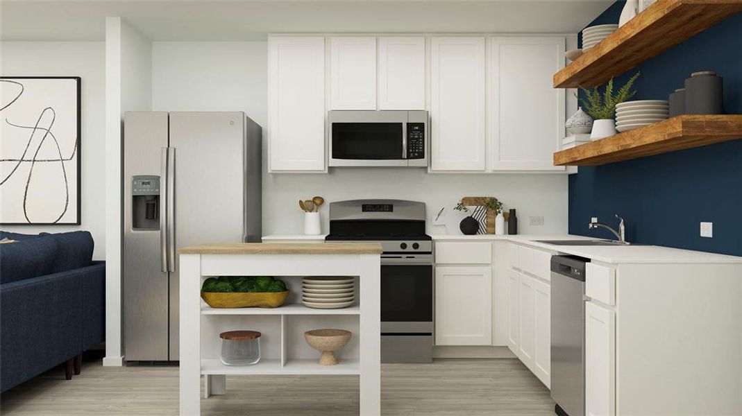 Kitchen with sink, white cabinets, light hardwood / wood-style floors, and appliances with stainless steel finishes