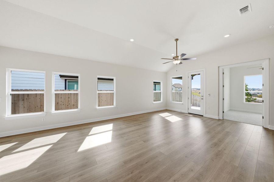 Spare room featuring light wood-style flooring, ceiling fan, recessed lighting, and vaulted ceiling Spare room featuring light wood-style flooring, ceiling fan, recessed lighting, and vaulted ceiling
