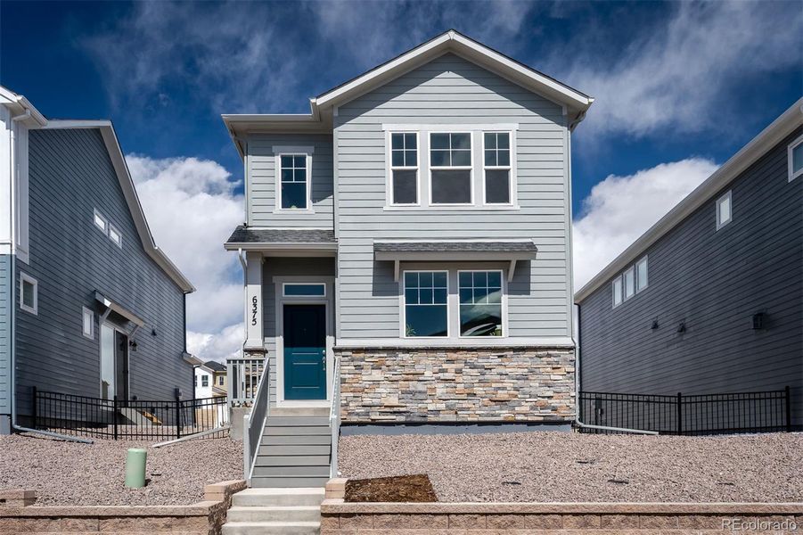 Front exterior of a home in the Revel Crossing at Wolf Ranch – The Ascent Collection community, located in Colorado Springs, CO (Image 10).