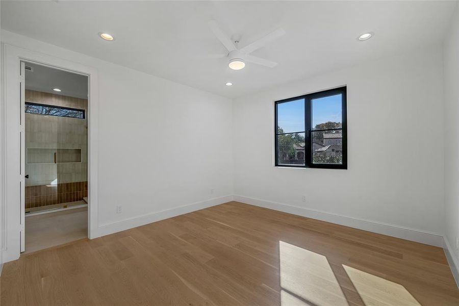 Open room featuring wood-finish flooring and white walls