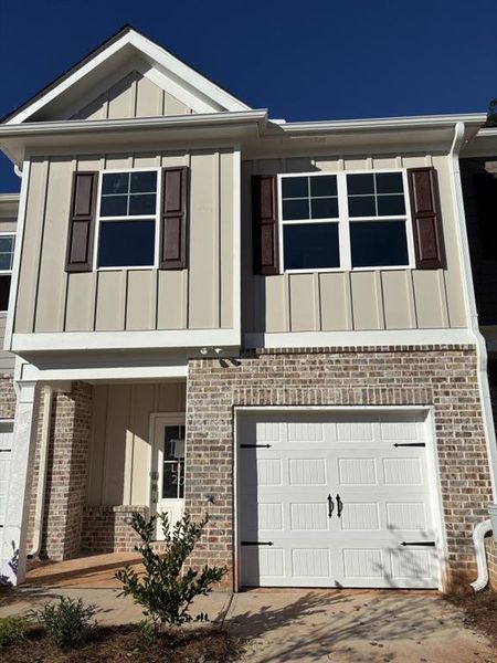 Exterior details and patio area of a home in The Reserve At Clock Tower, Douglasville (Image 1).