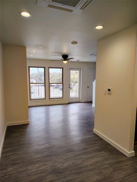 Spare room with ceiling fan and dark wood-type flooring