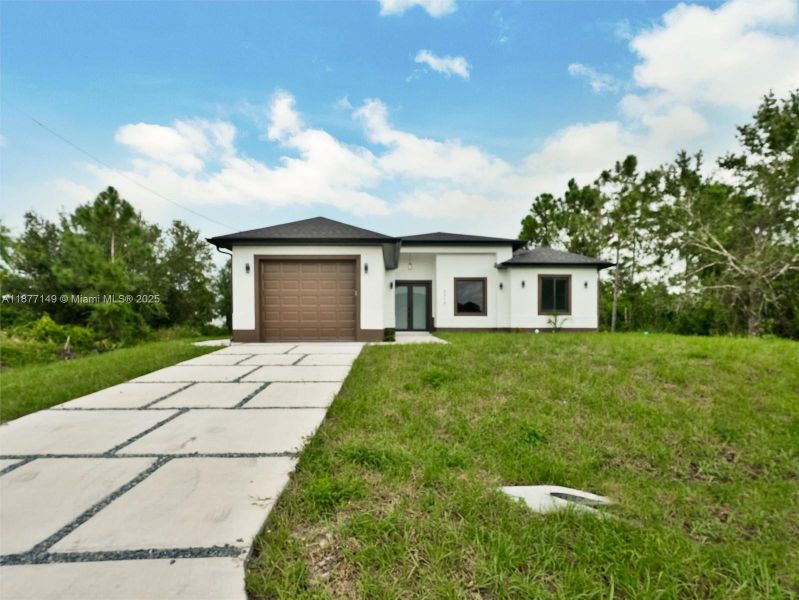 Front exterior of a new home in , Lehigh Acres, FL, highlighting curb appeal (Image 20).
