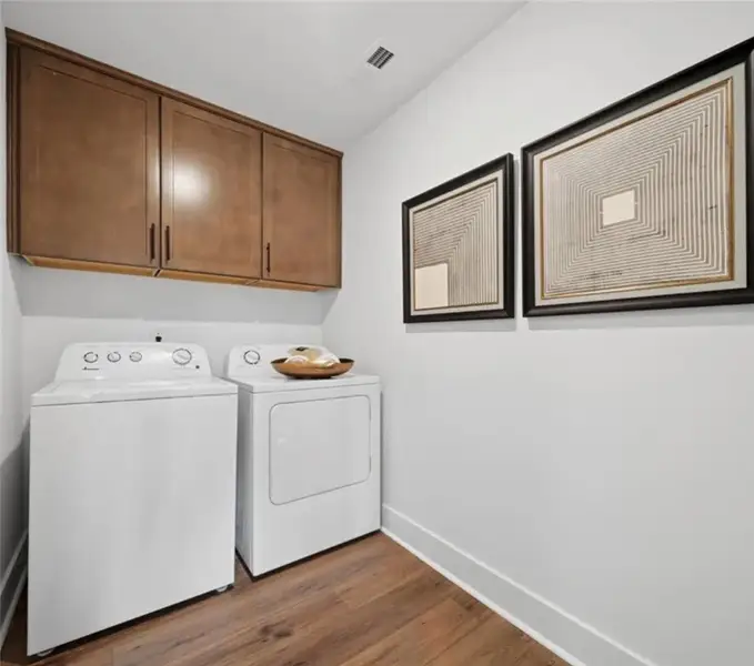 Streamlined laundry area with convenient overhead Streamlined laundry area with convenient overhead
