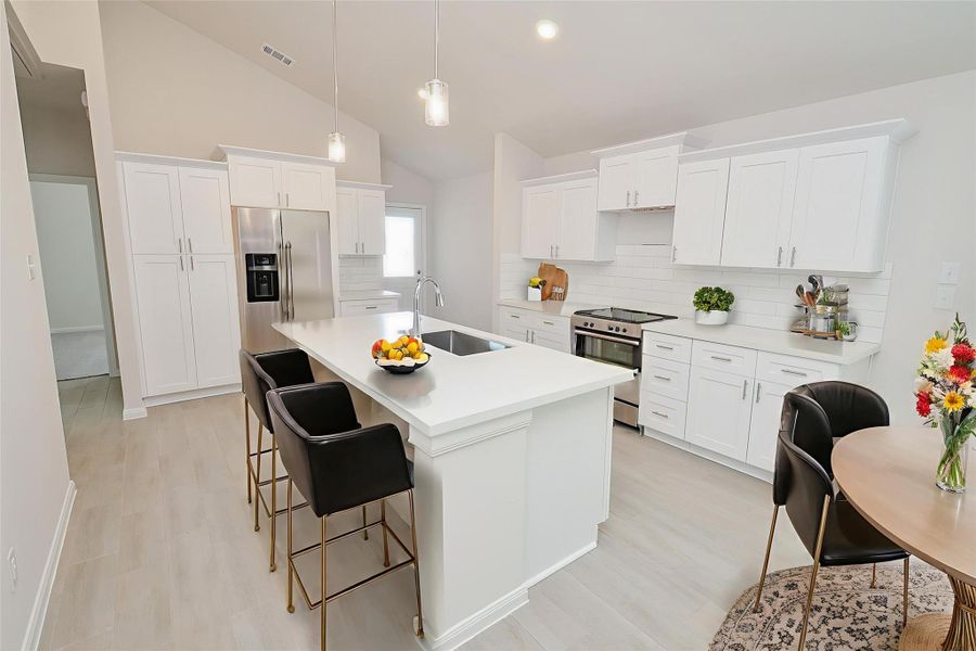 A large center island offers additional workspace, a deep sink, and casual seating, perfect for morning coffee or a quick meal. A large center island offers additional workspace, a deep sink, and casual seating, perfect for morning coffee or a quick meal.