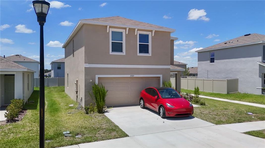 Front exterior of a new home in Westgate at Avalon Park, Wesley Chapel, FL, highlighting curb appeal (Image 2). Front exterior of a new home in Westgate at Avalon Park, Wesley Chapel, FL, highlighting curb appeal (Image 2).