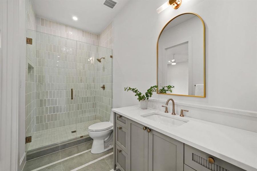 Bathroom with vanity, a shower stall, dark tile patterned floors, and recessed lighting Bathroom with vanity, a shower stall, dark tile patterned floors, and recessed lighting