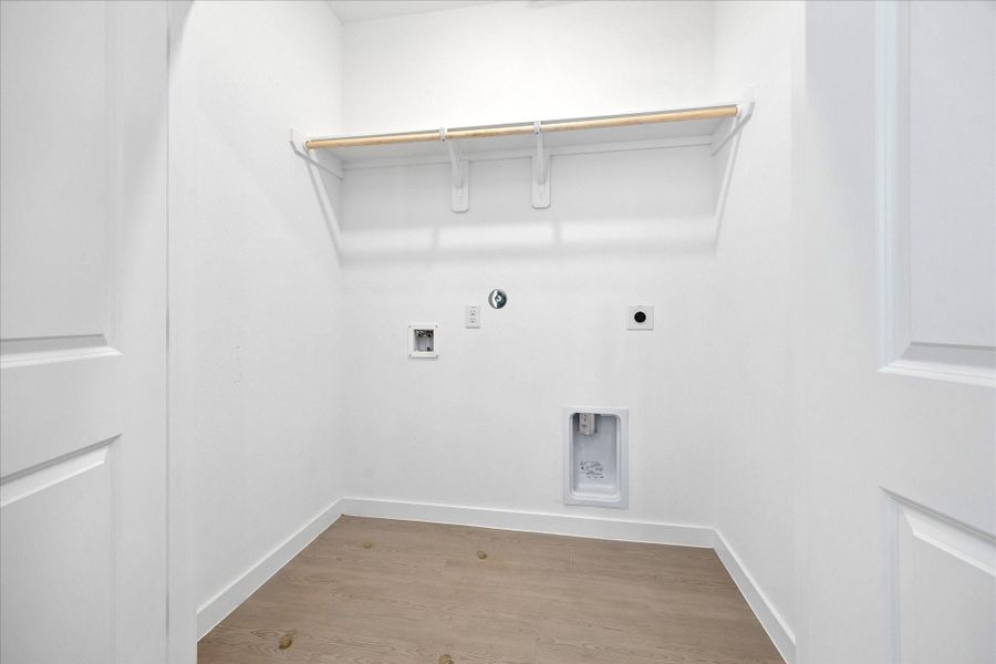 Laundry day may never be exciting, but at least it can be easy. This dedicated utility room keeps the washer and dryer tucked neatly away, with extra shelving overhead for supplies and everyday storage.