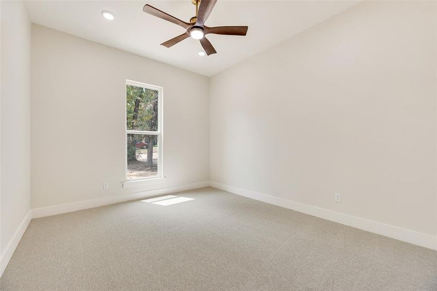 Spare room featuring light colored carpet, recessed lighting, and a ceiling fan
