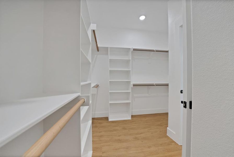 Spacious closet with light wood-style flooring