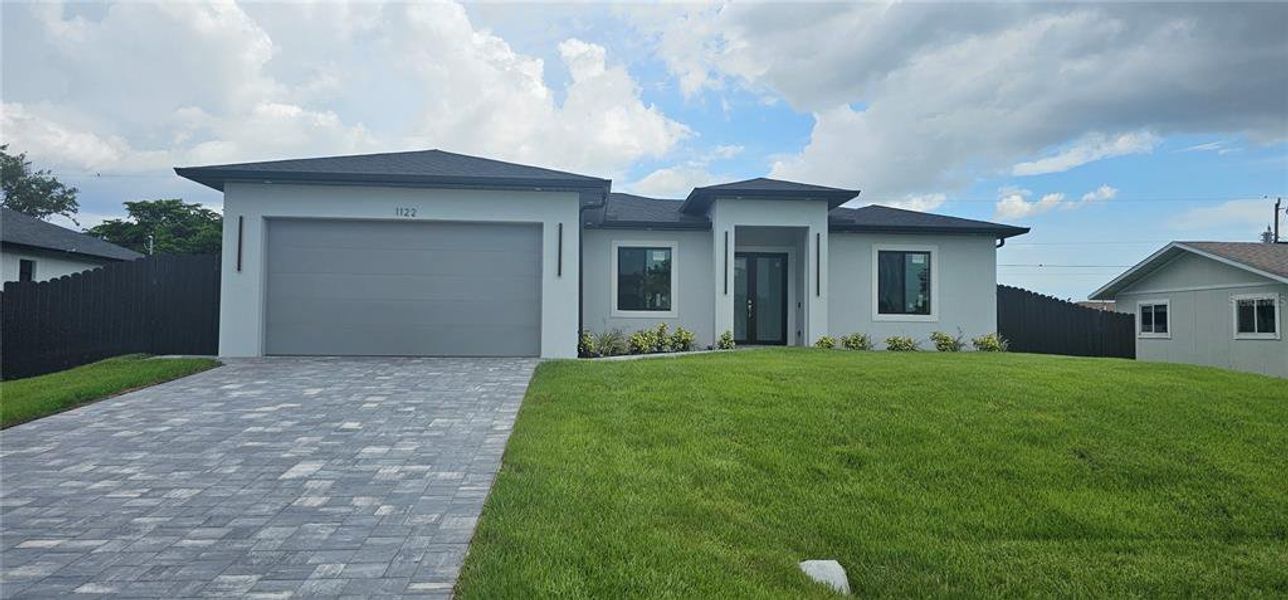 Front exterior of a new home in , Cape Coral, FL, highlighting curb appeal (Image 13). Front exterior of a new home in , Cape Coral, FL, highlighting curb appeal (Image 13).