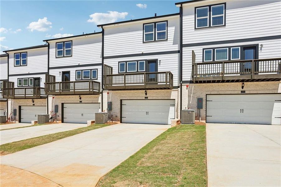 Front exterior of a new home in Hemingway - Highland Series, Cumming, GA, highlighting curb appeal (Image 24). Front exterior of a new home in Hemingway - Highland Series, Cumming, GA, highlighting curb appeal (Image 24).