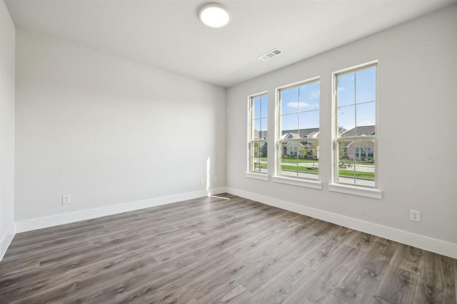 Empty room featuring wood-type flooring