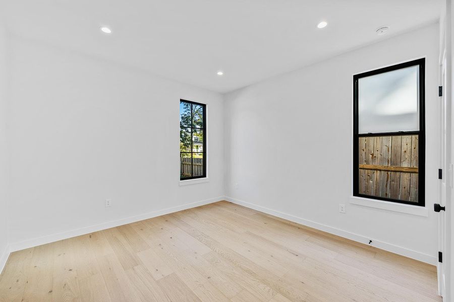 Spare room with light wood-style flooring and recessed lighting