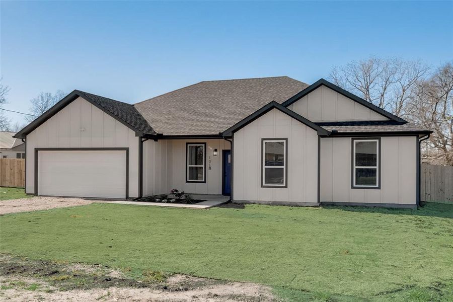 View of front of house featuring a garage and a front yard