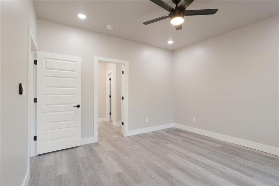 Spare room with ceiling fan and light hardwood / wood-style flooring