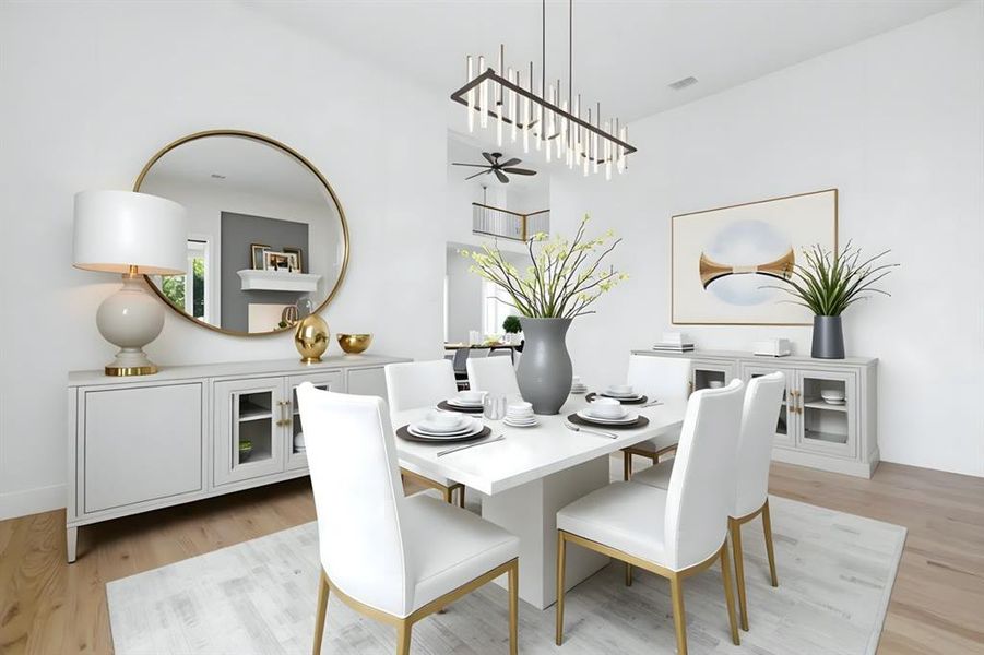 VIRTUALLY STAGED Dining room featuring light wood finished floors and ceiling fan VIRTUALLY STAGED Dining room featuring light wood finished floors and ceiling fan