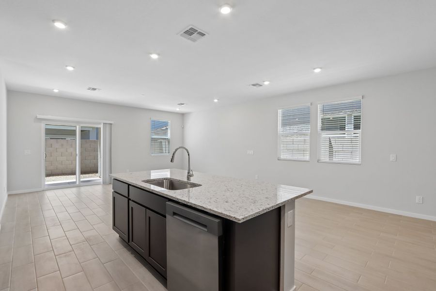 A kitchen with a sink and a counter top.