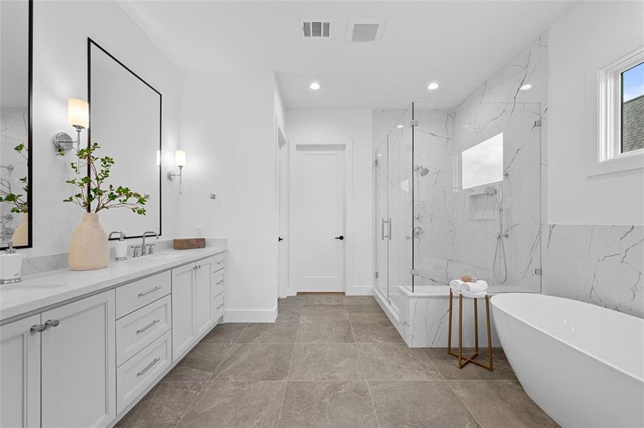 Gorgeous primary bath with designer tile and walk in shower and soaker tub