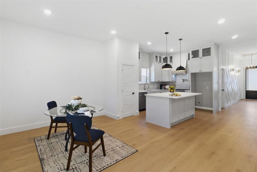 Open-concept living space featuring light wood-finish flooring throughout