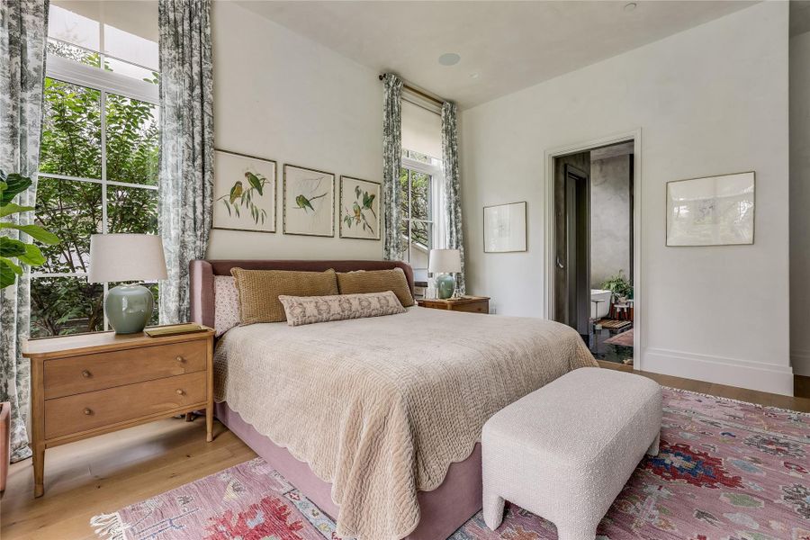 The tranquil primary bedroom features abundant natural light, and also total-darkness blackout shades for restful sleeps.