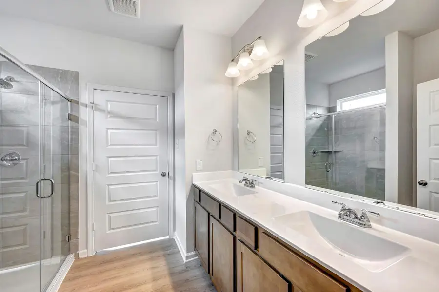The Davenport II- Primary Bathroom with Walk-in Shower and Dual Vanities. Sample floor plan photo used for illustrative purposes only. Upgrades, selections options, and colors will vary. The Davenport II- Primary Bathroom with Walk-in Shower and Dual Vanities. Sample floor plan photo used for illustrative purposes only. Upgrades, selections options, and colors will vary.