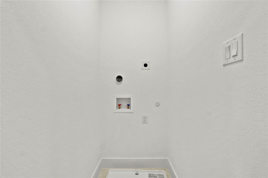Laundry area featuring gas dryer hookup, washer hookup, a textured wall, and hookup for an electric dryer