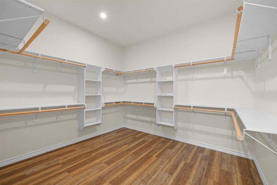 Walk in closet with dark wood finished floors Walk in closet with dark wood finished floors