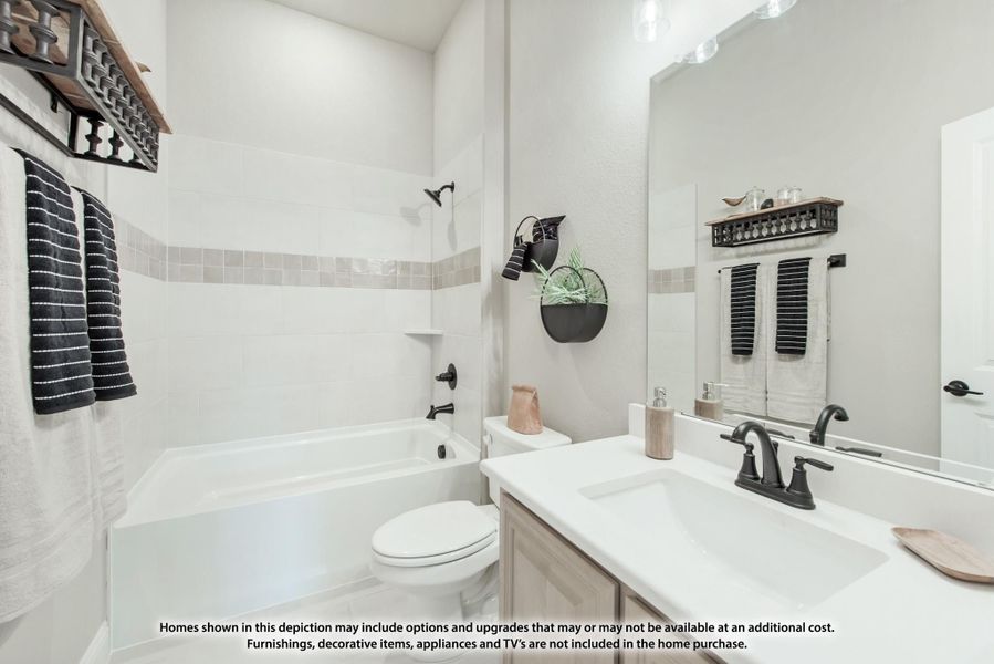 Bathroom with white tub-shower combo, single vanity, and black fixtures against white tile walls Bathroom with white tub-shower combo, single vanity, and black fixtures against white tile walls
