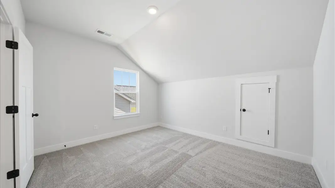 Notable bedroom offering soft carpet, a walk-in closet, and an expansive window overlooking the yard in Moore, SC