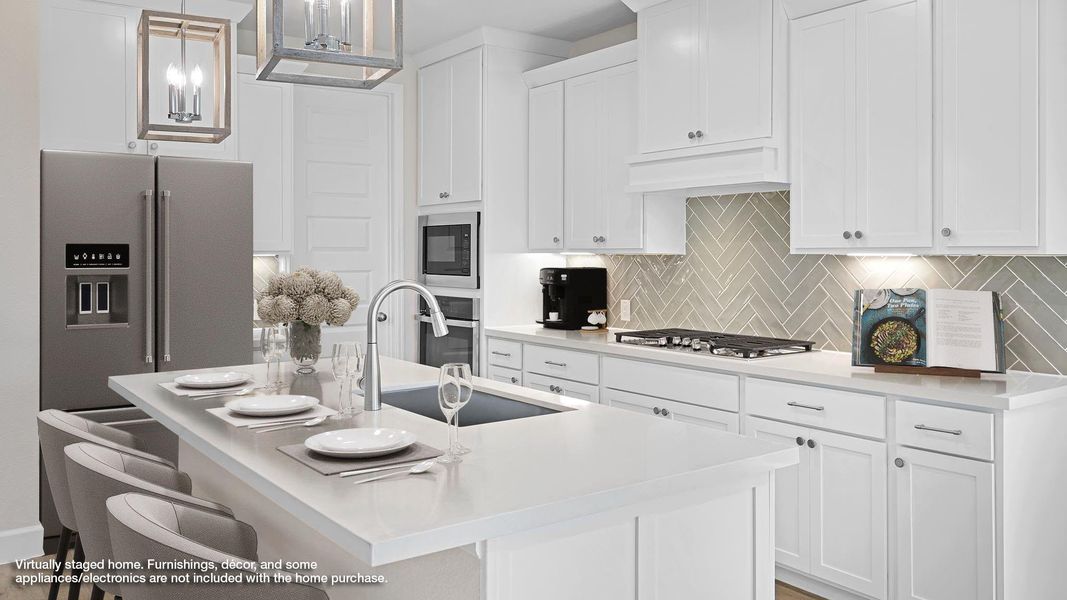 Kitchen with hanging light fixtures, a breakfast bar, decorative backsplash, a center island with sink, and white cabinetry