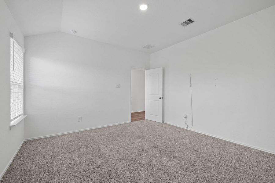 View from primary bath back to bedroom entrance.